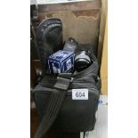 A Minolta camera lens, a Minolta flash gun, a tele-converter etc., in a camera bag.