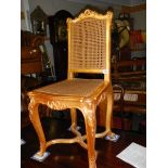 A good quality gilded salon chair with cane seat and back.