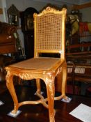 A good quality gilded salon chair with cane seat and back.