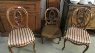 A pair of cabriole leg chairs and a matching nursing chair.