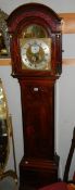 A long case clock with Adam and Eve automaton and moon phase and date dials.