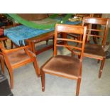 A mahogany dining table with 4 chairs.