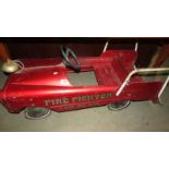 A Vintage firefighter fire engine pedal car.