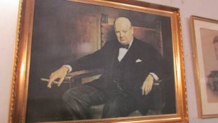 A gilt framed portrait print of Winston Churchill, signed and dated 1942.