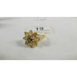 A 9ct gold ring in a floral design, size U.