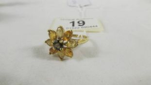 A 9ct gold ring in a floral design, size U.