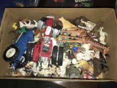 A box containing various plastic farm and zoo animals.