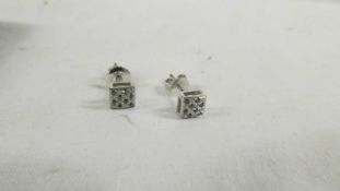 A pair of 14ct white gold and diamond stud earrings.