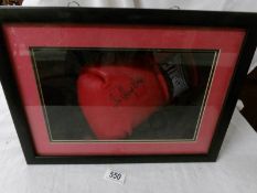 A cased signed boxing glove, Sir Henry Cooper.