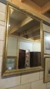 A bevel edged gilt framed mirror, 87 x 110 cm.