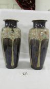 A pair of 25 cm Royal Doulton vases signed Eliza Simmons.