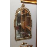 A metal framed gilt ormolu mirror.