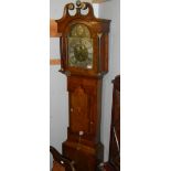 A 19th century Grandfather clock with brass and silvered dial in an oak and mahogany case.
