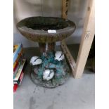 A concrete garden bird bath with badger base.