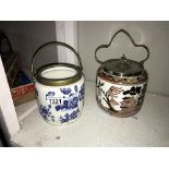 An Indian tree pattern biscuit barrel and a blue and white example with no lid.
