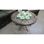 A Ship's wheel coffee table with glass top.