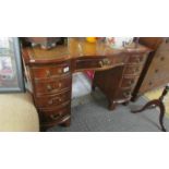 A good quality mahogany kneehole desk with leather inset top.