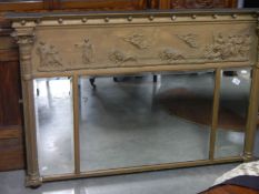 A gilded overmantel mirror with Roman chariot scene across top.