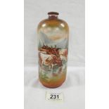 A Victorian hand painted vase depicting 5 cows in water with a background of mountains,
