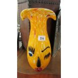 A colourful studio glass clown faced vase.