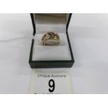 A ruby and sapphire open Welsh gold work ring in a wide band in 9ct gold, size M.