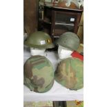 4 military helmets.