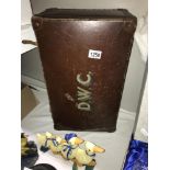 A vintage suitcase with 'DWC' monogram.