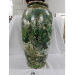 A good Japanese vase in various shades of green with figures having tea in a garden, 37 cm.