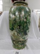 A good Japanese vase in various shades of green with figures having tea in a garden, 37 cm.