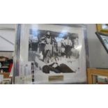 A framed and glazed photograph of Cassius Clay with The Beatles with certificate of authenticity
