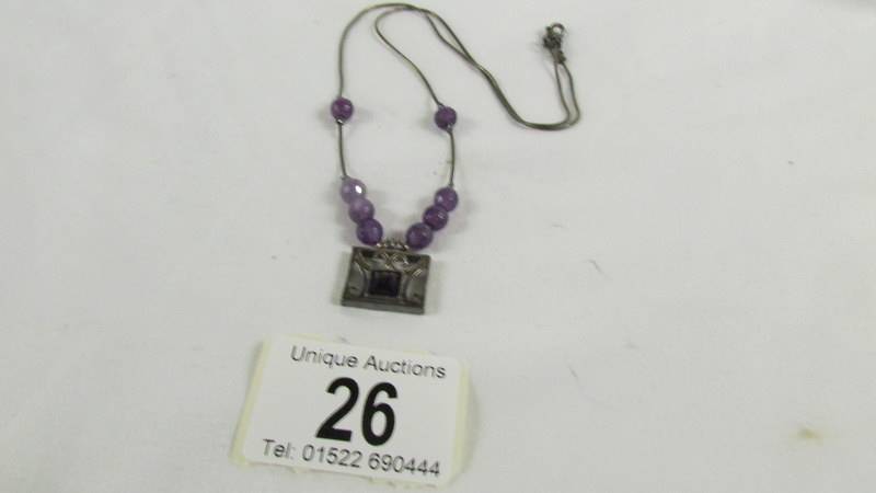 A silver pendant necklace.