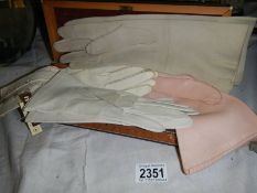 An early 20th century glove box with bone inlay and a quantity of vintage gloves.