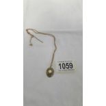 A 9ct gold and pearl pendant on 9ct gold chain, 5.6 grams total, (chain needs fixing).