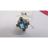 A very unusual design blue topaz and diamond ring in 9ct gold.