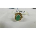 A 14ct gold jade ring in an oval design, size L.