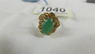 A 14ct gold jade ring in an oval design, size L.