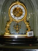 A good French alabaster mantel clock under dome with swinging cherub pendulum, complete and working.