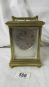 A late 19th century striking carriage clock with reverse painted on glass panels,