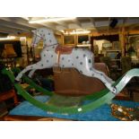 A large early rocking horse on bowed rockers.