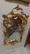 A gilded plastic framed mirror.