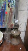 A brass oil lamp and 4 oil lamp chimneys.