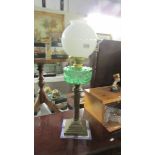 A Victorian brass column oil lamp with green glass font (burner converted to electric but font not