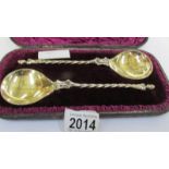 A cased pair of apostle spoons dated 1883.