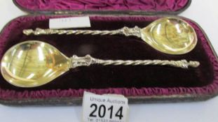 A cased pair of apostle spoons dated 1883.