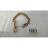 A gold bracelet with safety chain and padlock, 21.2 grams.