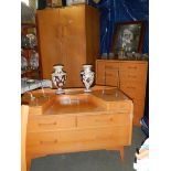 A 1960's bedroom suite comprising wardrobe, dressing table and chest of drawers.