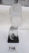 A frosted glass nude female figurine.