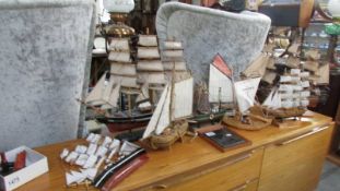 7 model sailing boats and 2 wall plaques.