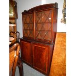 A mahogany inlaid glazed top bookcase.