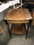 A Victorian inlaid tea trolley with drop leaves.